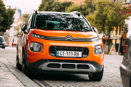 Batumi, Adjara, Georgia - March 20, 2022: Orange citroen c3 aircross car parked on street. subcompact crossover SUV