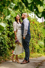 handsome guy with flowers kisses his fiancee