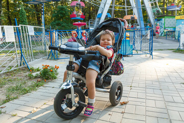 Obraz na płótnie Canvas beautiful little girl sitting on a bike