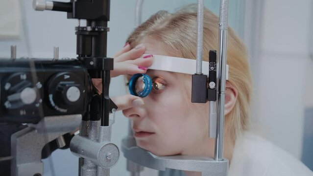 ophthalmologist examining the eyesight of woman with a slit lamp