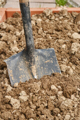 Digging soil with shovel. Shallow depth of field