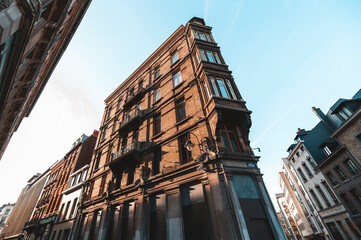 Typical Brussels apartment building in the city center with warm sunlight