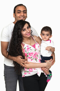 Studio portrait of a young family on a white background. High quality photo