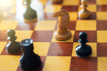 A game of chess.Knight's move. Wooden chess piece of a horse. © Svetliy