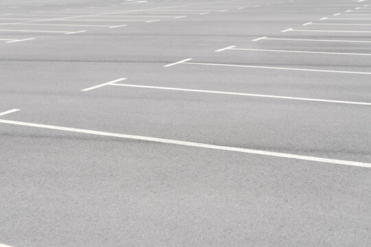 A car parking area with white painted lines, no cars parked. All places are available.