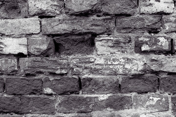 Old stone wall with peeling off plaste