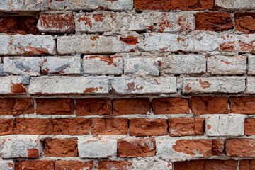 Old stone wall with peeling off plaste