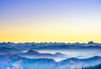 Sunrise over Himalaya mountains with mist and clouds. Himalayan range seen from Kufri, Himachal Pradesh at sunrise. 