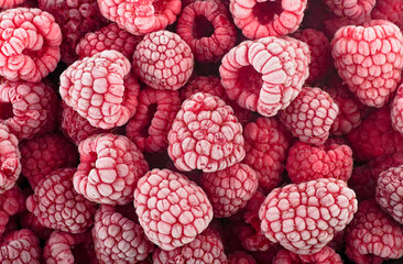 Top view of frozen raspberries covered with hoarfrost as background. Fresh berries.