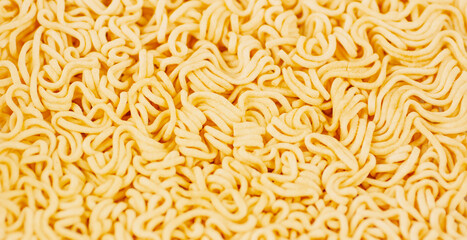 Texture of dry instant noodles. Background texture of dry pasta without spices and condiments. Macro.