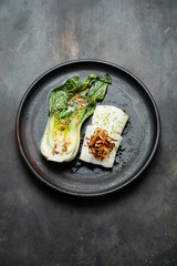 Tasty fried halibut fillet with bok choi, restaurant dish, top view