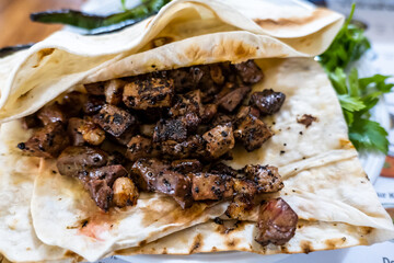 Ciger kabab (Ciğer kebabı in Turkish),  a common type of skewered meat served in Anatolian cuisine, usually eaten with sliced onions, salad and bread