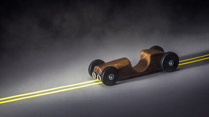Toy wooden racing car on the road