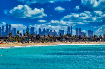 Fototapeta na wymiar View over sandy beach and Dubai downtown panorama in Dubai, UAE.