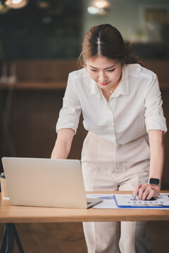 Portrait of a business woman working on a tablet computer in a modern office. Make an account analysis report. real estate investment information financial and tax system concepts