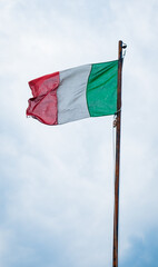 Flag of Italy on sky background. Italian flag waving in wind. 