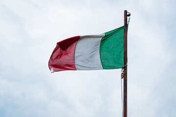Flag of Italy on sky background. Italian flag waving in wind. 