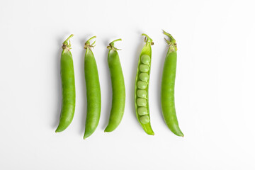 Fresh organic raw green peas pods on white background. Healthy eating, vegan and vegetarian legume food, raw food and detox super food, bean protein, isolated close up