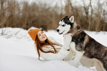 woman outdoors in a field in winter walking with a dog Lifestyle