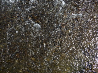 Rapid flow of the river. Big river, view from above. View from the bridge to the water. Thresholds on the water.
