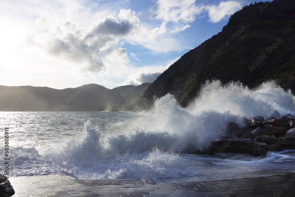 Poster rocks and waves on the sea near cinque terre - manarola, picturesque fishermen villages in the provi