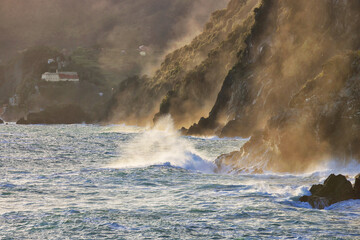 Rocks and waves on the sea near Cinque Terre - Manarola, picturesque fishermen villages in the province of La Spezia, Liguria, Italy