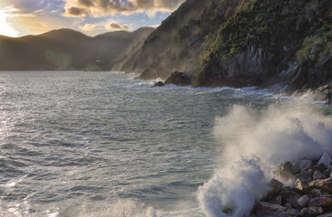 Rocks and waves in sunset light on the sea near Cinque Terre - Vernazza, in the province of La Spezia, Liguria, Italy, Europe