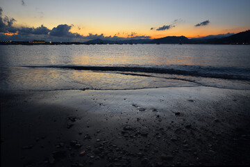 incredible colors and lights, a romantic sunset on the beach facing the sea in the magnificent Liguria