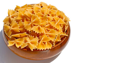 Uncooked bow tie pasta on white background.