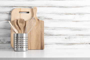 Kitchen utensils on wooden vintage gray wall background, home kitchen decor concept, front view