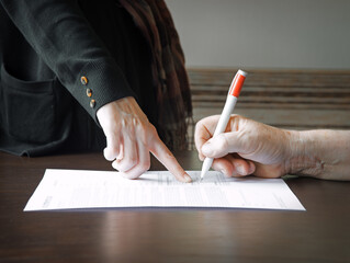 An old woman is forced to write a will for an apartment