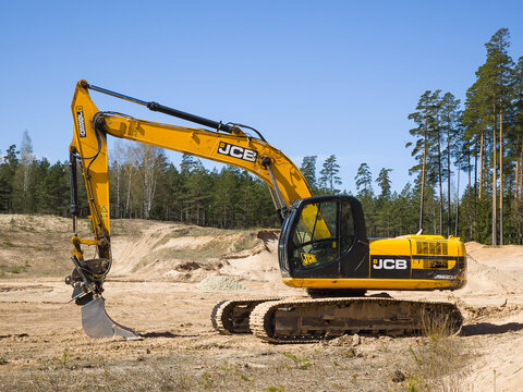 Skrunda, Latvia - May 3, 2022: Yellow excavator JCB JS 220 LC is located in a quarry.