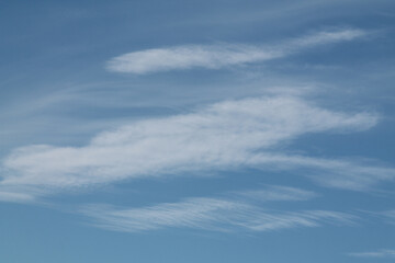 Naklejka na ściany i meble Cirrocumulus lenticularis clouds. Blue sky with white clouds