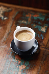 Coffee in glass cup on dark wooden background. Copy space.	