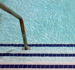 Steps and railing down into the swimming pool