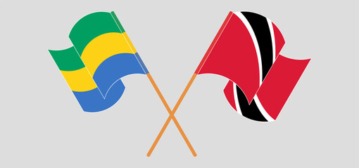 Crossed and waving flags of Gabon and Trinidad and Tobago