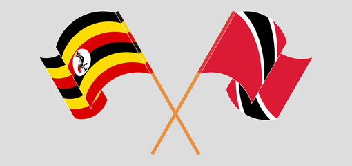 Crossed and waving flags of Uganda and Trinidad and Tobago