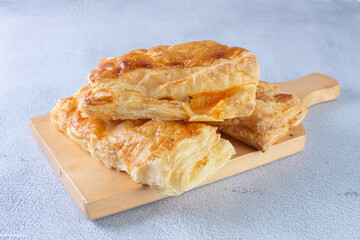 Ham and cheese puff pastry, displayed on gray background