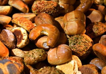 Different wheat and corn rolls, bread and bakery products background