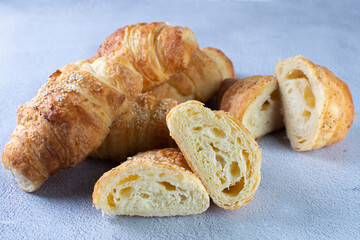 Gourmet cheese and sesame croissant, displayed on gray background