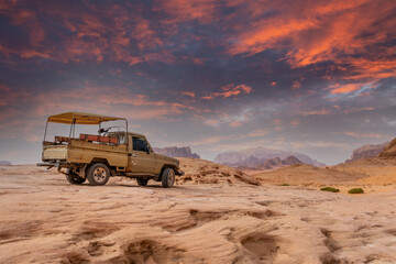 Fototapeta na wymiar Old bedouin car with sandstones sunset landscape of Wadi Rum desert, Jordan