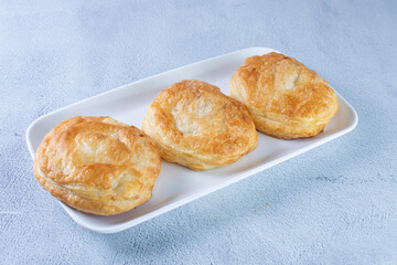 Puff pastry of arequipe, displayed on gray background