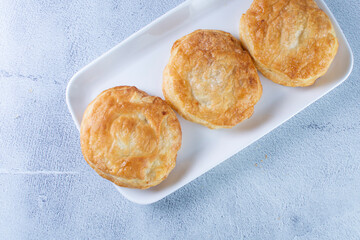 Puff pastry of arequipe, displayed on gray background