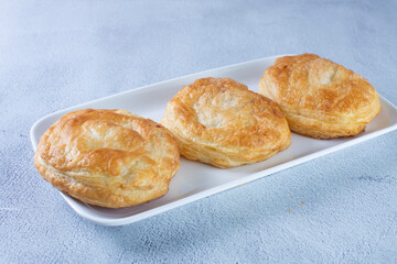 Puff pastry of arequipe, displayed on gray background