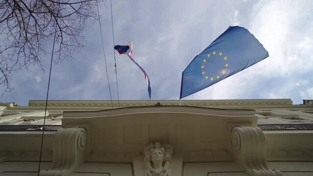 Croation flag and the flag of Europian Union against blue sky in Zagreb, Croatia