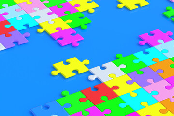 Naklejka premium Lot of unfinished colorful puzzle jiggle pieces on blue background. 3d render