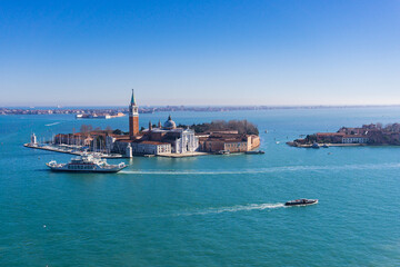 Areal view of  San Giorgio Maggiore island of Venice on a sunny winter day with boat traffic around it