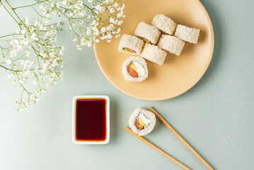 japanese sushi rolls with fish and rice balls on a colored backg © Cavan