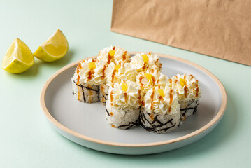 japanese sushi rolls with a cheese cap on a colored background