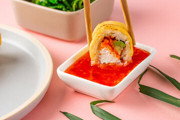 japanese sushi rolls in cheddar cheese on a colored background